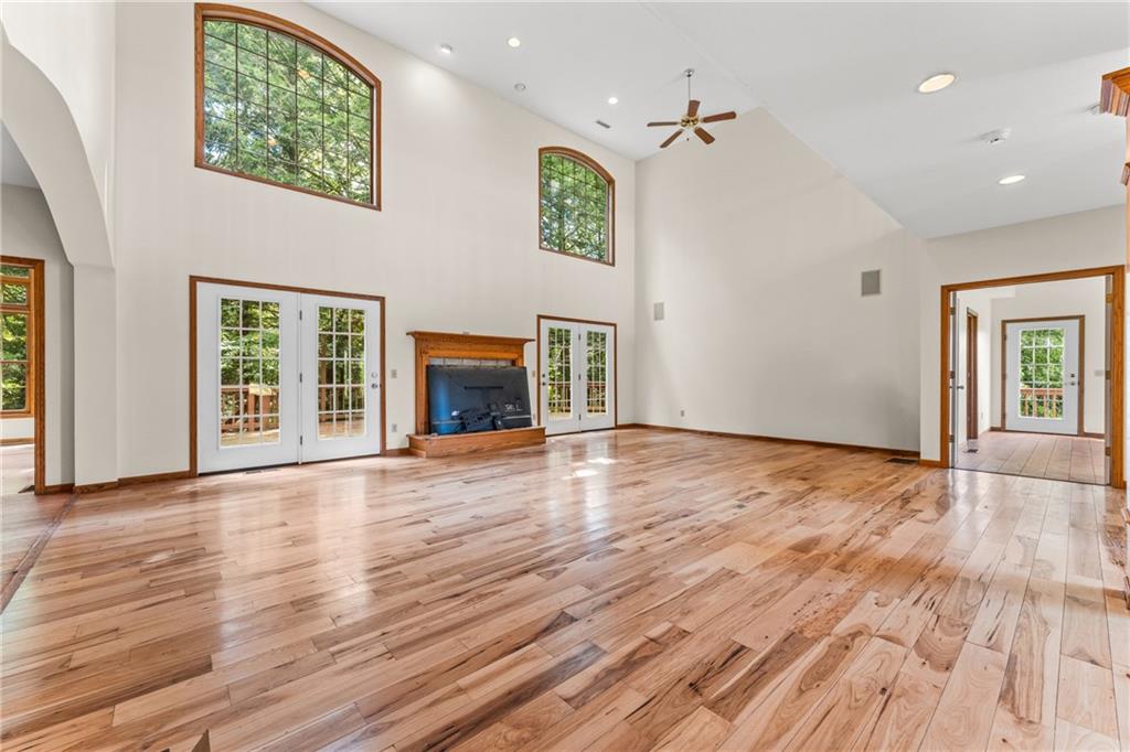 810 Hamburg Road Fredonia, PA 16124 - Photo 17 of 45 an empty room with wooden floor fireplace and windows