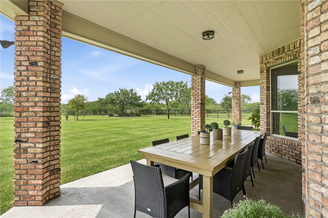 8710 KIng Ranch Drive Corpus Christi, TX 78414 - Photo 26 of 38 a view of a patio with a table chairs and garden