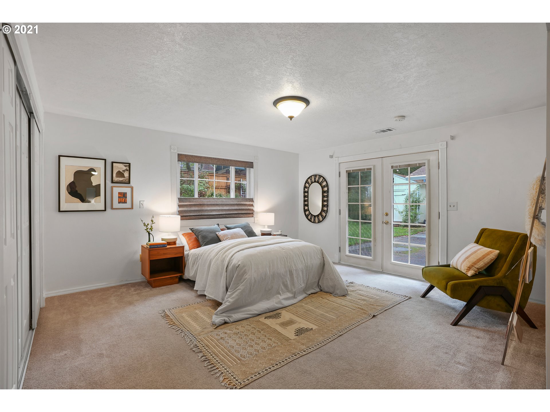 45 Southwest Collins Street Portland, OR 97219 - Photo 17 of 28 a bedroom with a bed and glass window