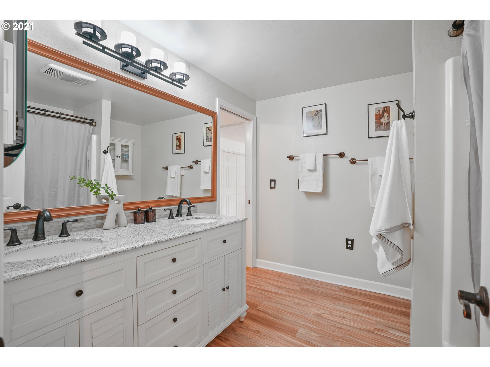 45 Southwest Collins Street Portland, OR 97219 - Photo 22 of 28 a bathroom with a double vanity sink and mirror with shower