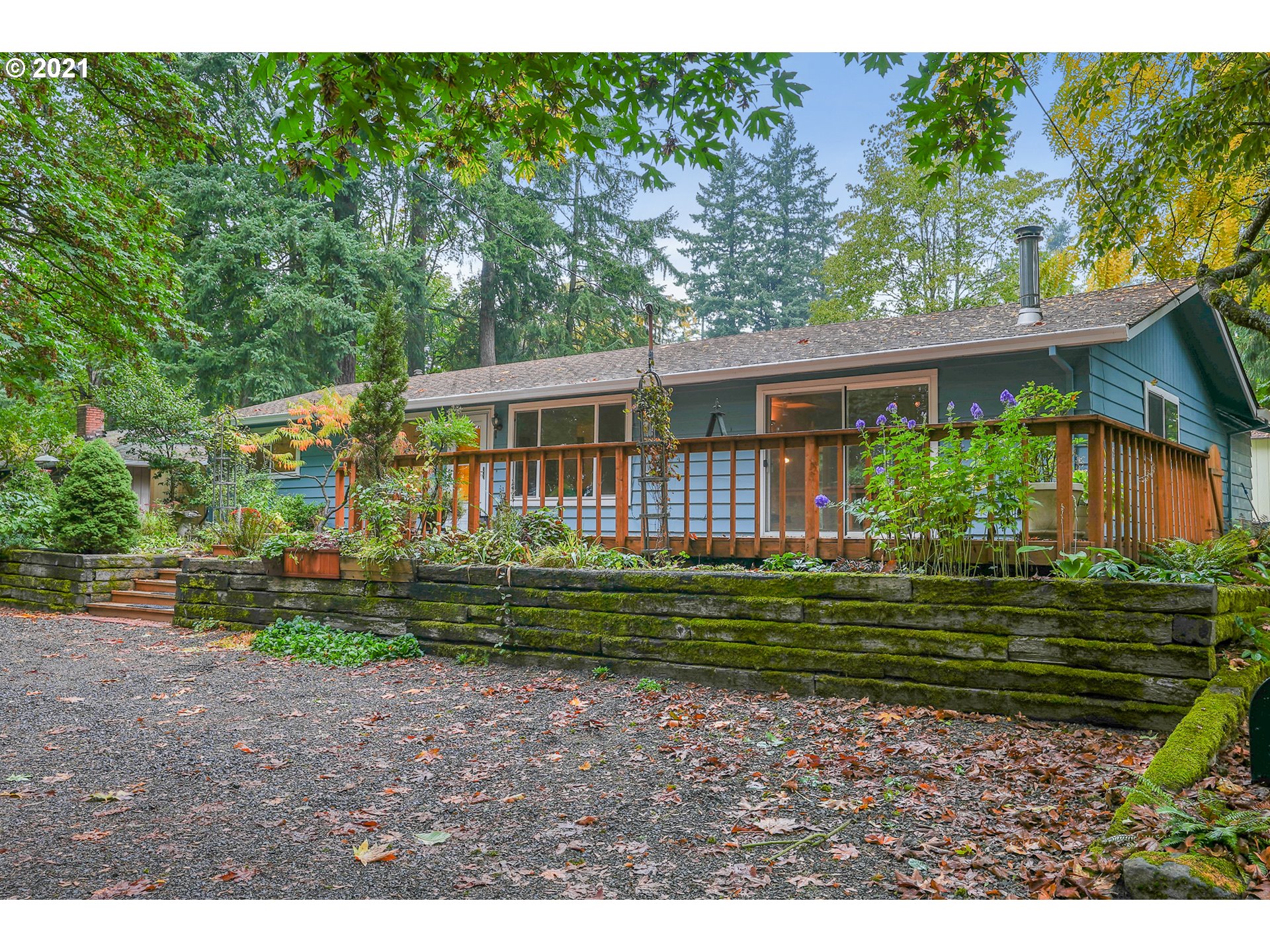 45 Southwest Collins Street Portland, OR 97219 - Photo 3 of 28 a view of a house with a yard and a garden