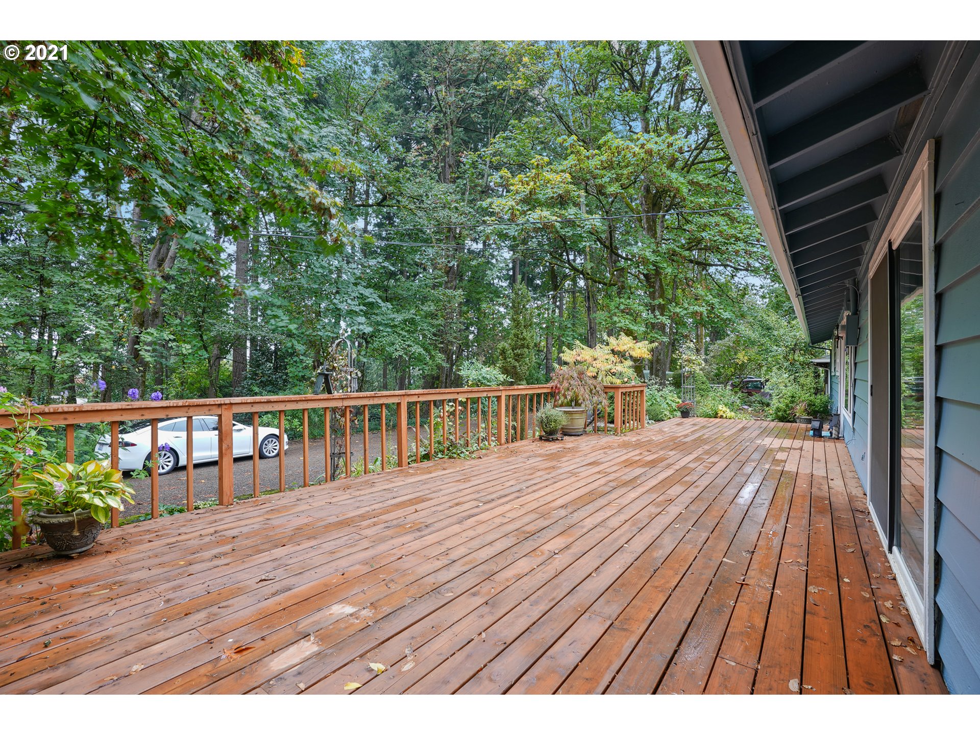 45 Southwest Collins Street Portland, OR 97219 - Photo 4 of 28 a view of backyard with a deck and wooden floor