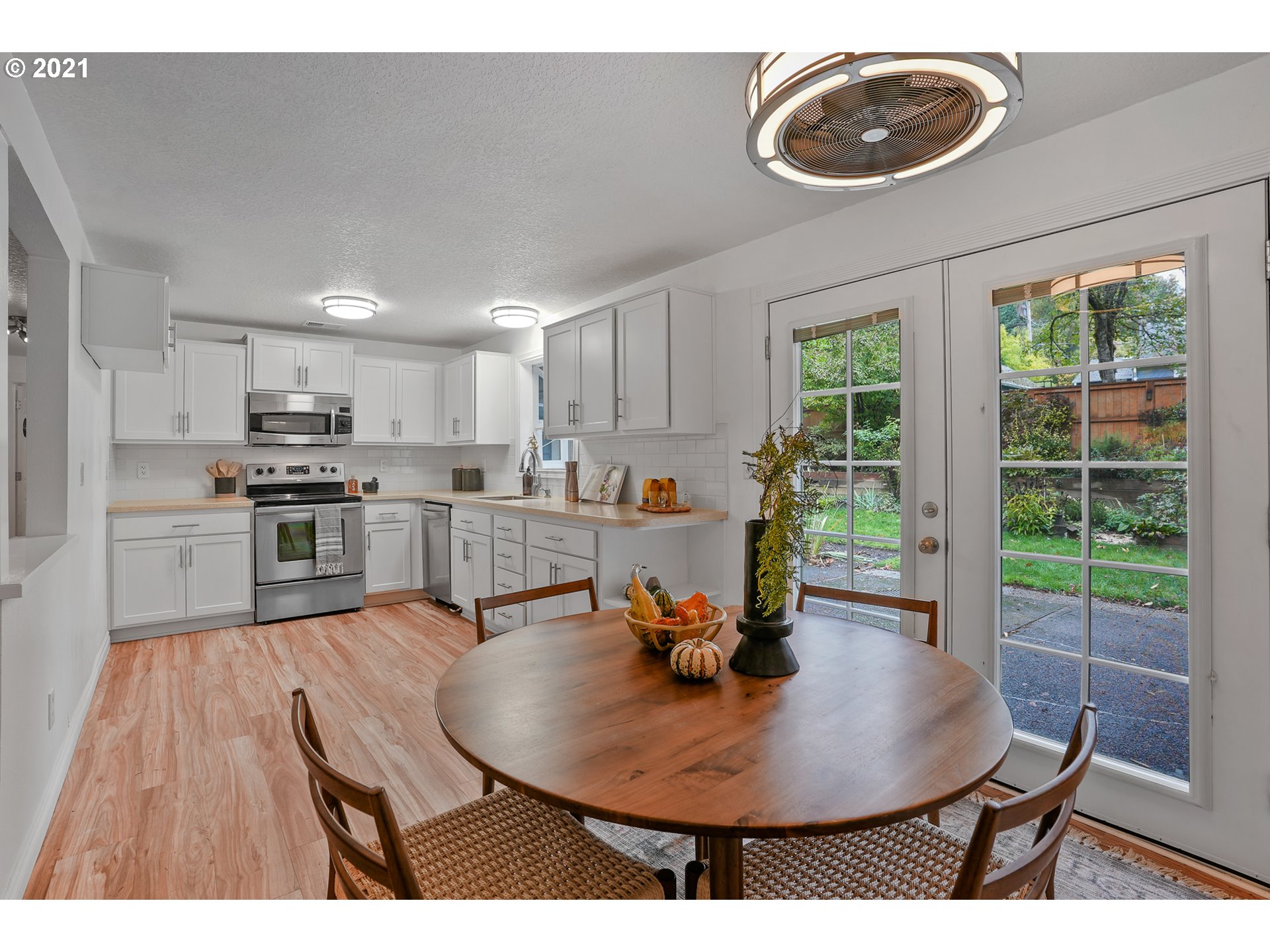 45 Southwest Collins Street Portland, OR 97219 - Photo 10 of 28 a open kitchen with dining table and wooden floors