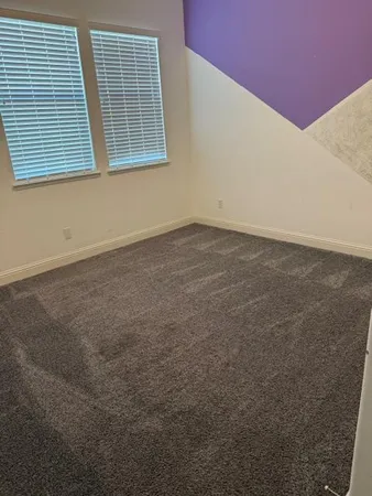 a bed sitting in a room next to a window