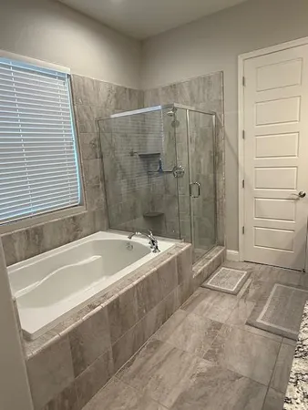 an empty room with windows and ceiling fan