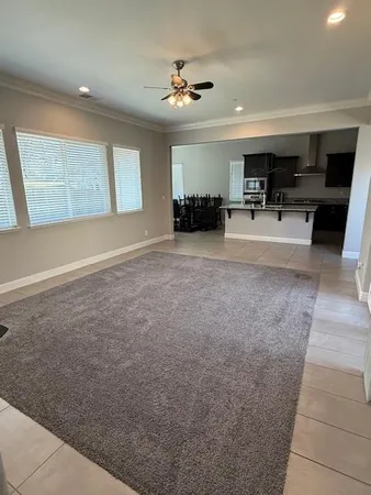a view of kitchen with furniture and a ceiling fan