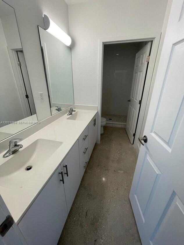 23935 Southwest 110th Court, Unit 23935 Homestead, FL 33032 - Photo 5 of 10 a bathroom with a double vanity sink and a mirror