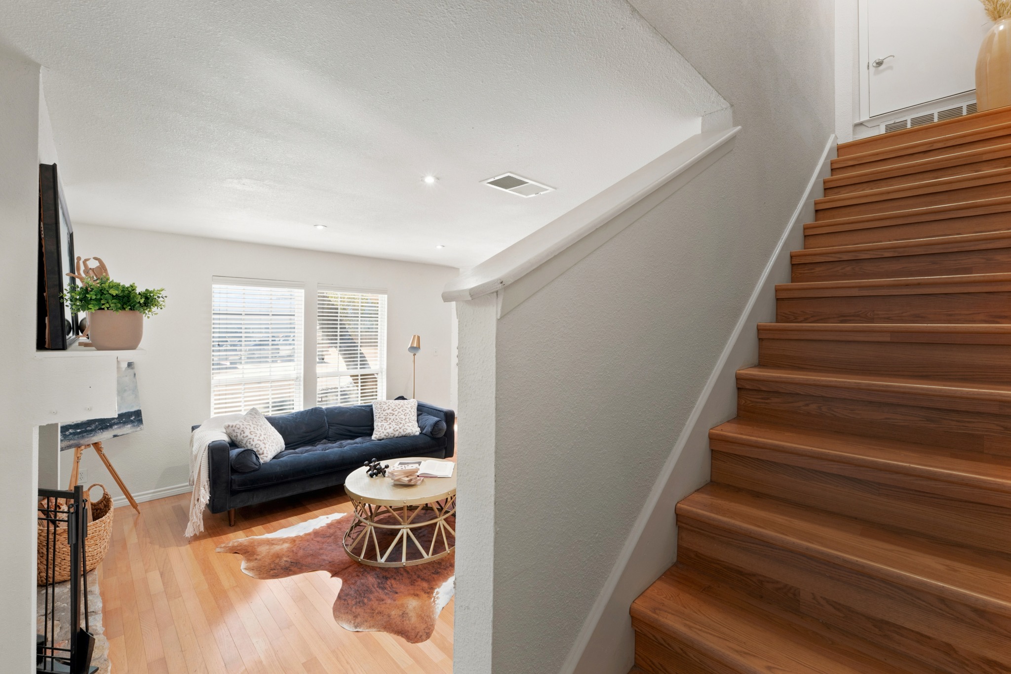 1504 Allen Road, Unit B Austin, TX 78746 - Photo 13 of 24 Rich wood stairs descend into a comfortable living area detailed with recessed lighting.