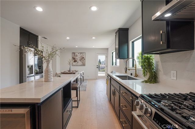 a kitchen with lots of counter top space and stainless steel appliances