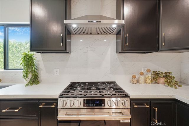 a stove top oven sitting inside of a kitchen