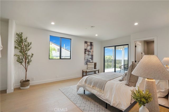 a bedroom with a bed and a potted plant