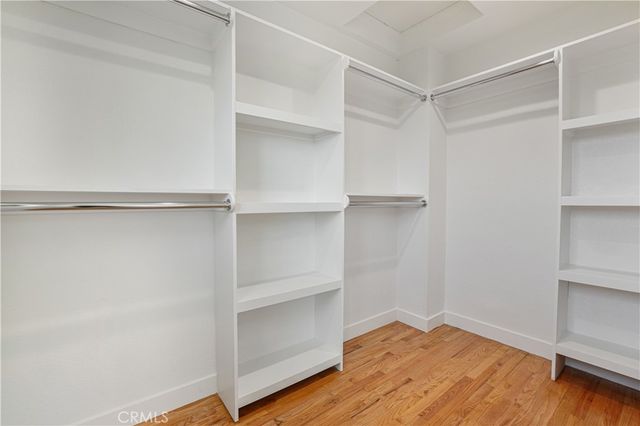 a view of walk in closet with empty racks