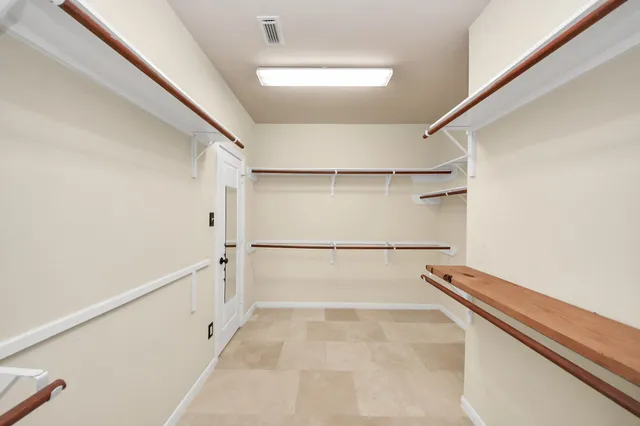 a view of a room with wooden floor and a ceiling fan