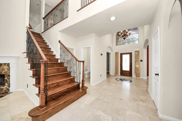 a view of an empty room with a fireplace and a window