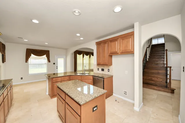 a kitchen with stainless steel appliances granite countertop a sink and cabinets