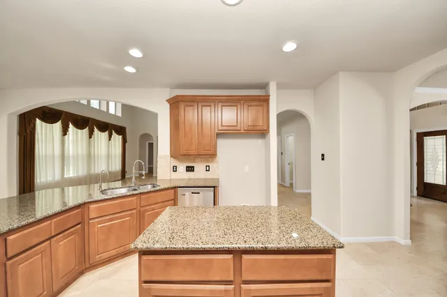 a kitchen with a sink stove and refrigerator
