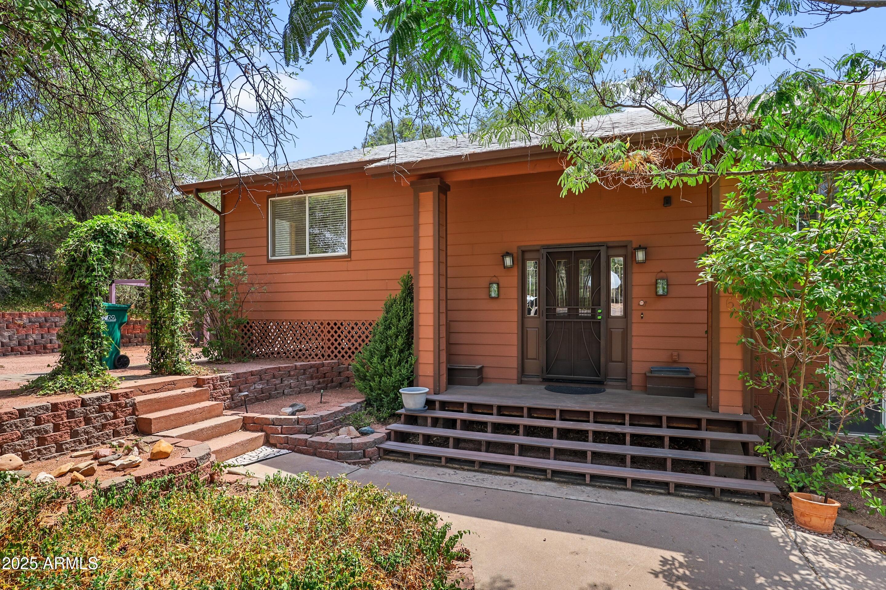 1506 North Easy Street Payson, AZ 85541 - Photo 1 of 17 a front view of a house with a garden
