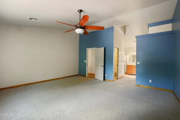 a view of empty room with ceiling fan