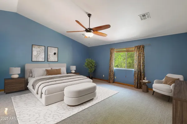 a bedroom with a bed couch and window