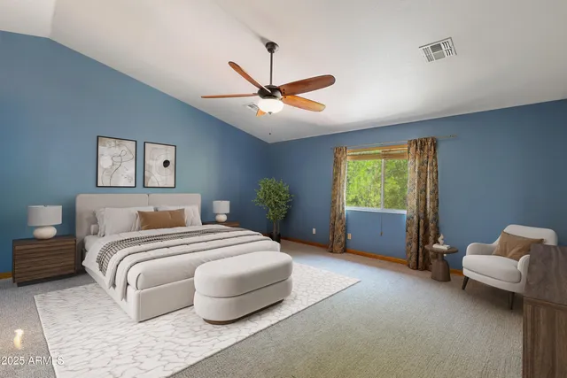 a bedroom with a bed couch and window