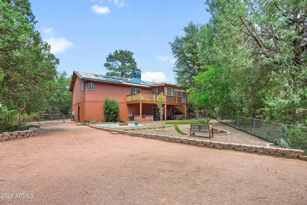 a front view of a house with a yard and potted plants