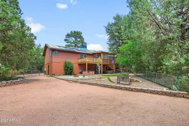a front view of a house with a yard and potted plants