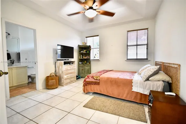 a bedroom with a bed and flat screen tv