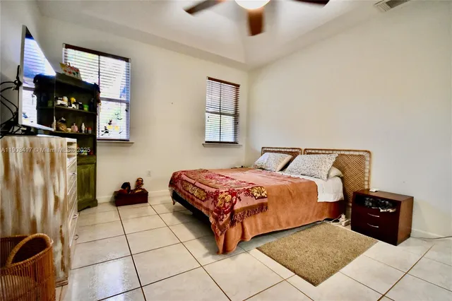 a bedroom with a bed and two windows