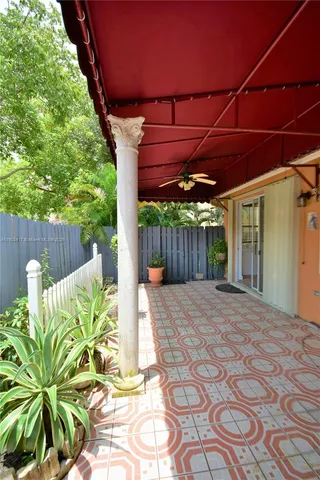 a view of a backyard with wooden fence