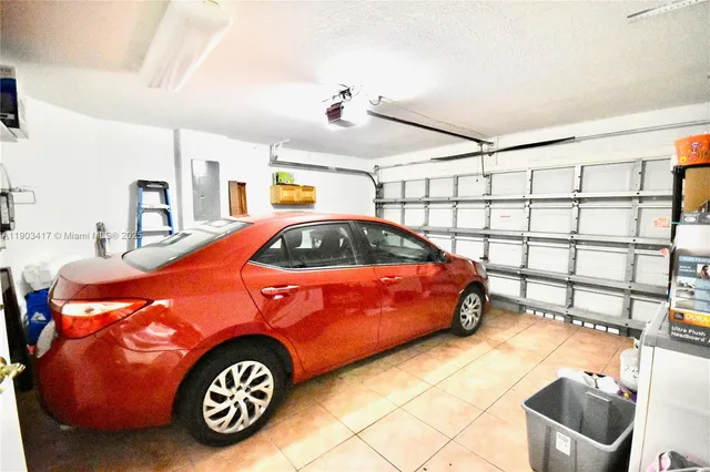 a view of a house with a yard and palm trees