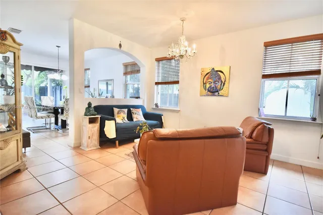 a living room with furniture a table and chairs