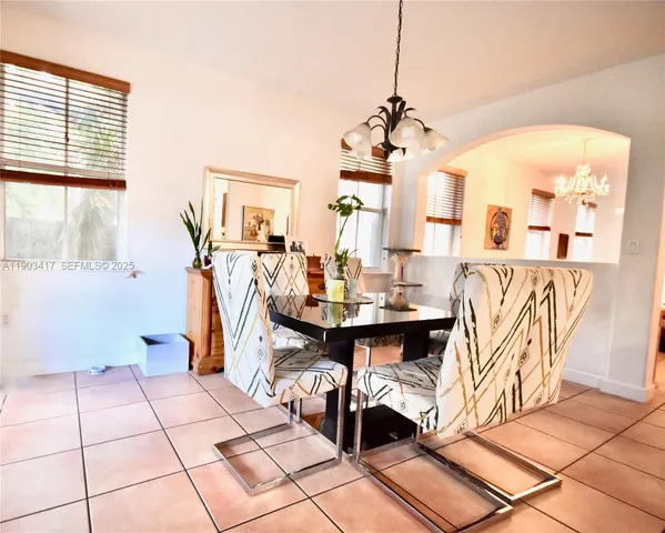 a view of a dining room with a table and chairs