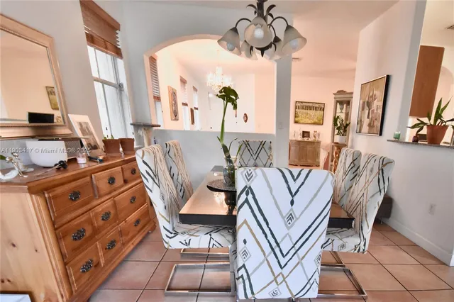 a view of a livingroom with furniture a flat screen tv and a large window