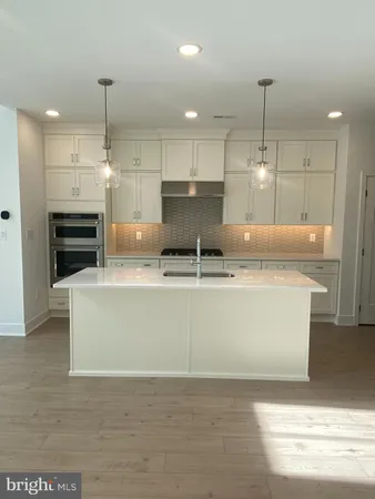 a view of kitchen with stainless steel appliances granite countertop stove top oven and refrigerator