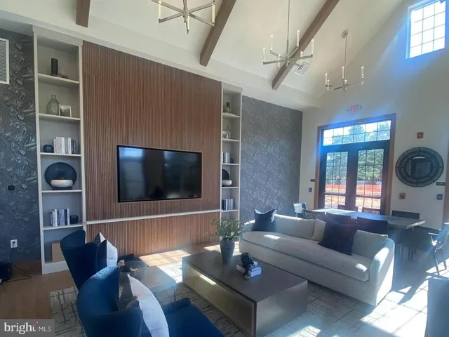 a living room with a table and a potted plant