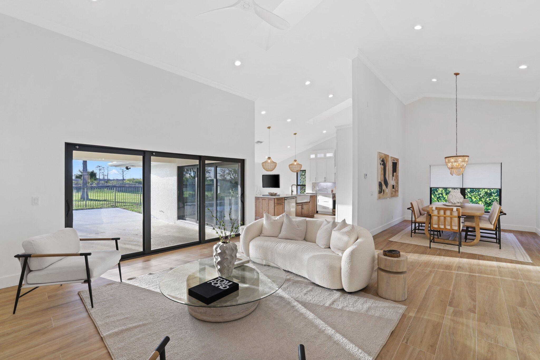 24 Dunbar Road Palm Beach Gardens, FL 33418 - Photo 15 of 93 a living room with furniture and a large window