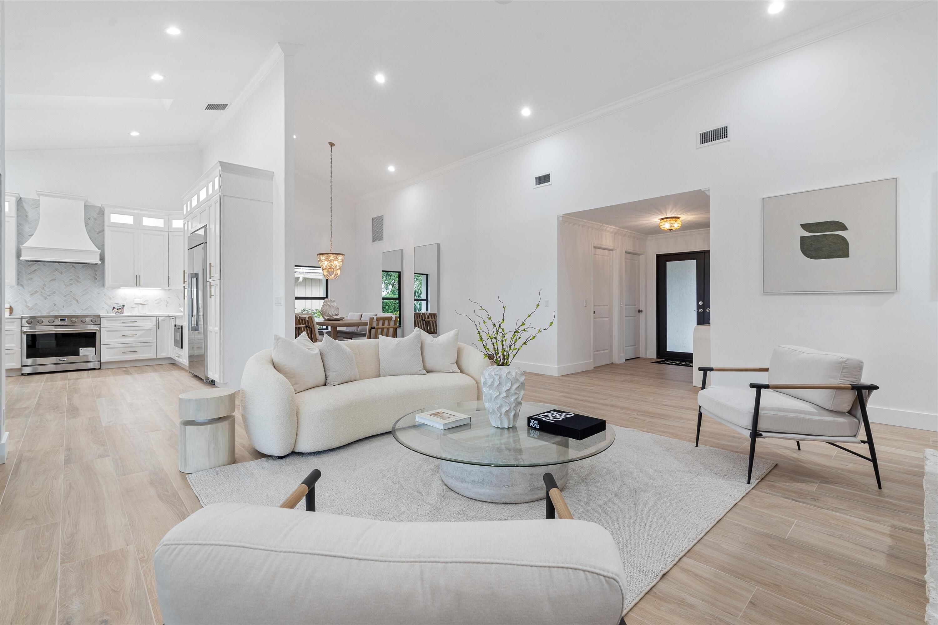 24 Dunbar Road Palm Beach Gardens, FL 33418 - Photo 18 of 93 a living room with furniture and a table