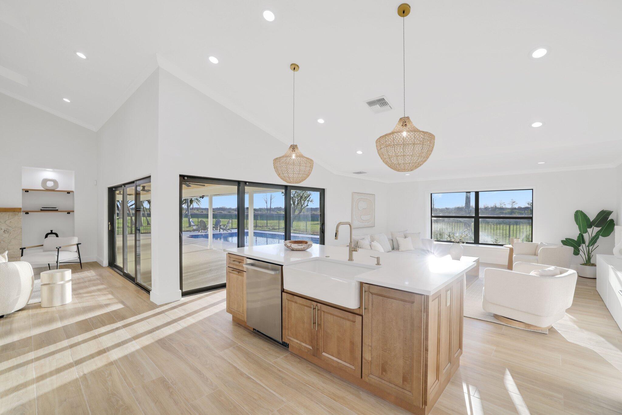 24 Dunbar Road Palm Beach Gardens, FL 33418 - Photo 21 of 93 a large white kitchen with a large window