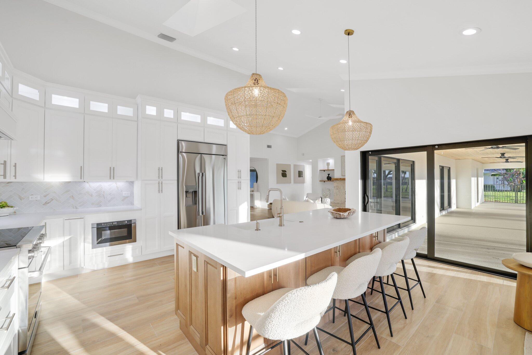 24 Dunbar Road Palm Beach Gardens, FL 33418 - Photo 24 of 93 a large kitchen with a table and chairs