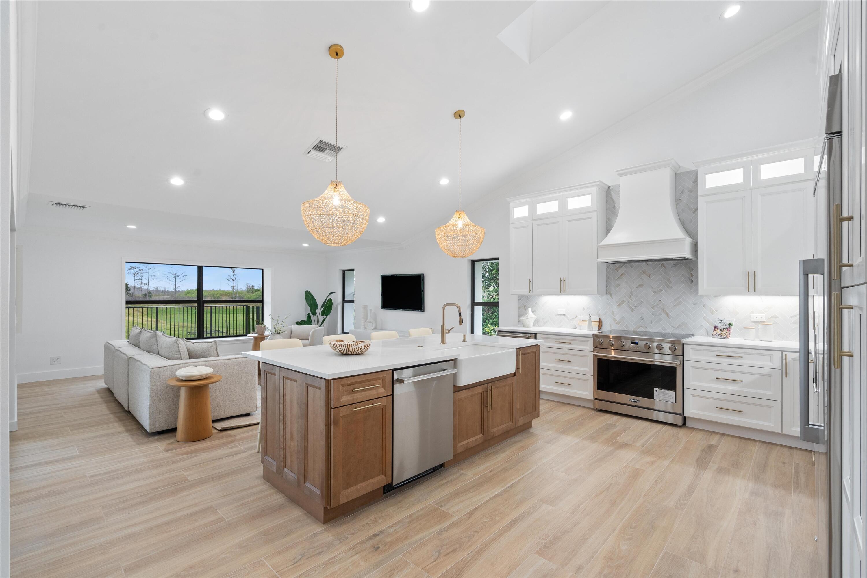 24 Dunbar Road Palm Beach Gardens, FL 33418 - Photo 27 of 93 a kitchen with a stove and a wooden floors