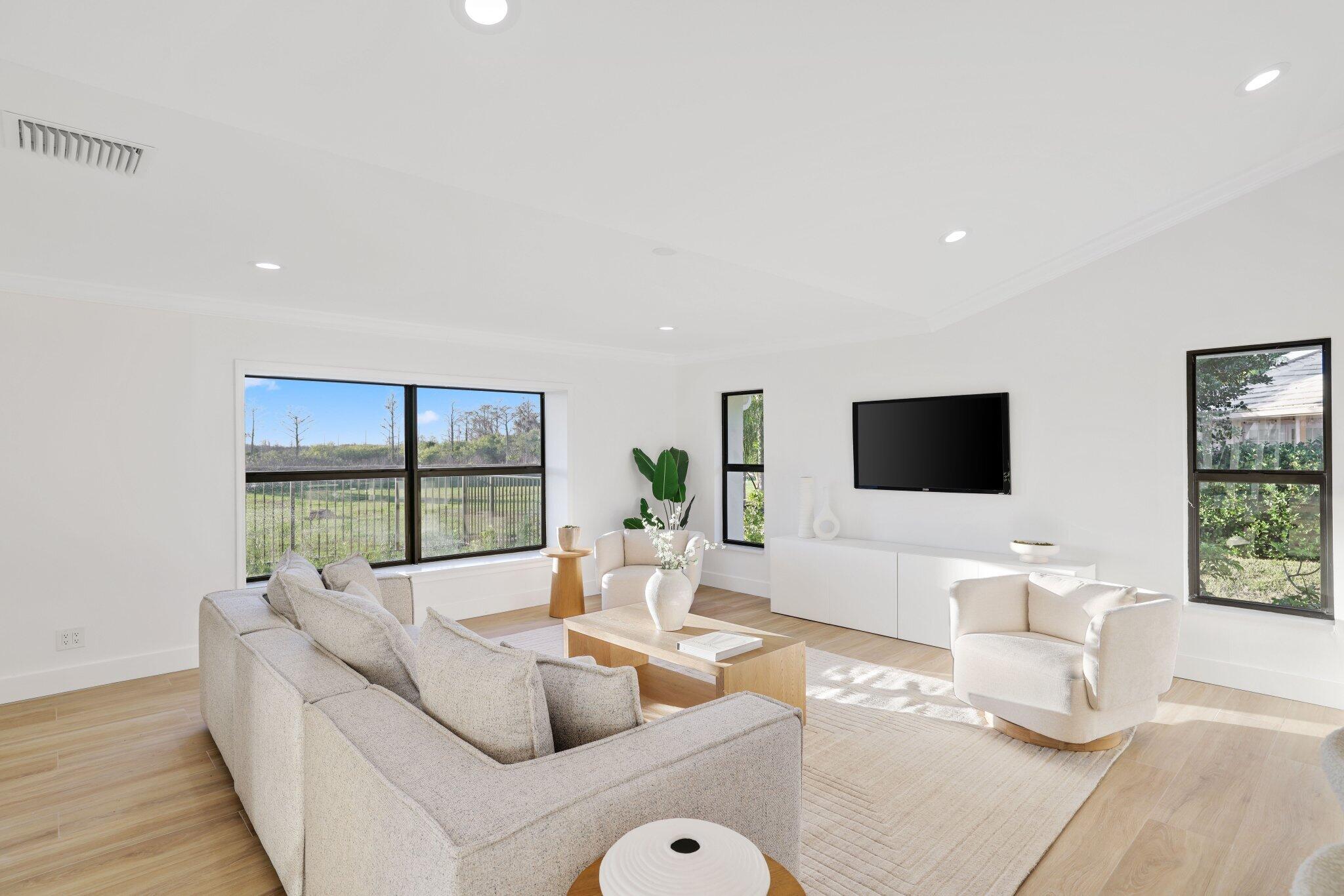 24 Dunbar Road Palm Beach Gardens, FL 33418 - Photo 35 of 93 a living room with furniture and a flat screen tv