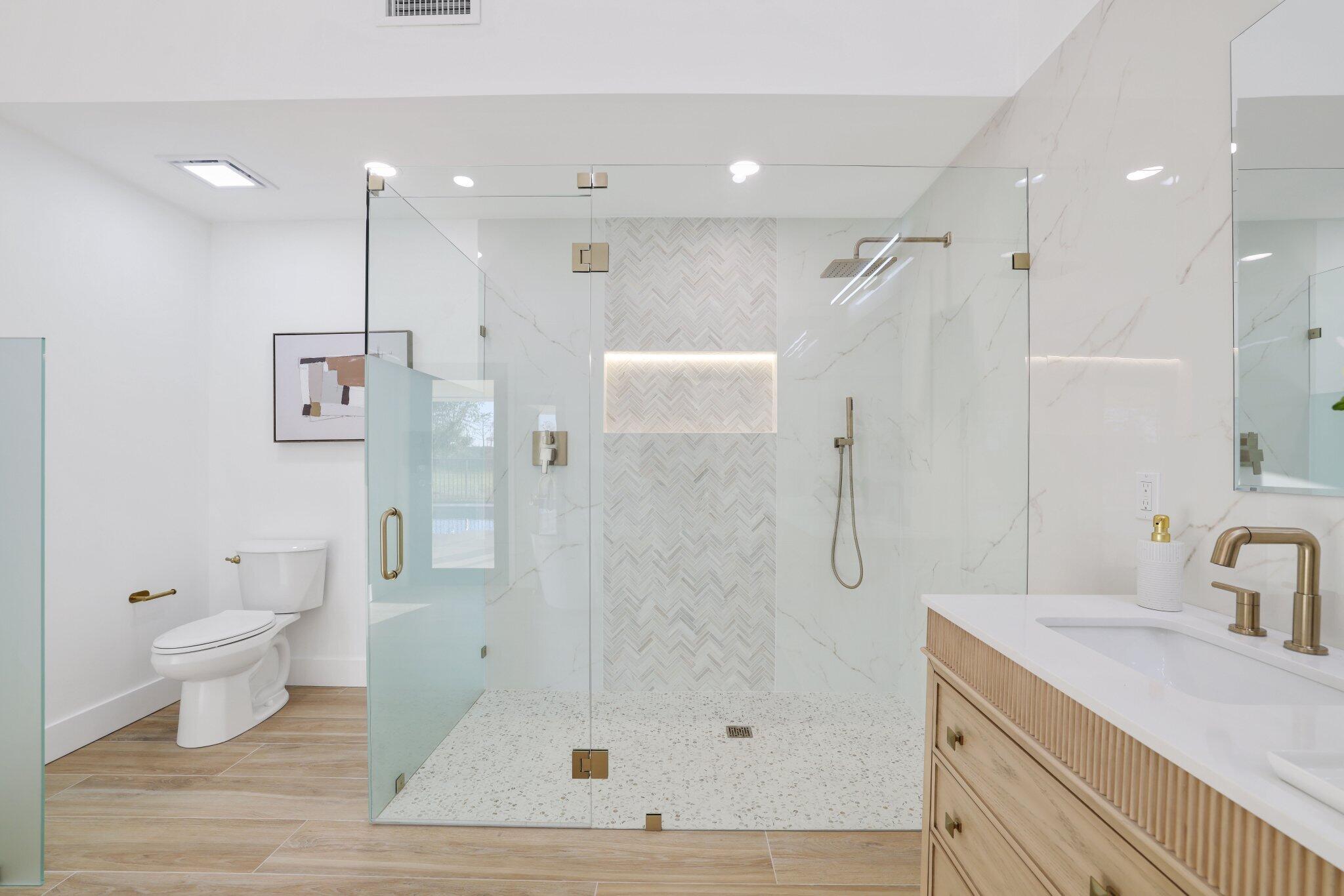 24 Dunbar Road Palm Beach Gardens, FL 33418 - Photo 46 of 93 a bathroom with a granite countertop sink a toilet and shower