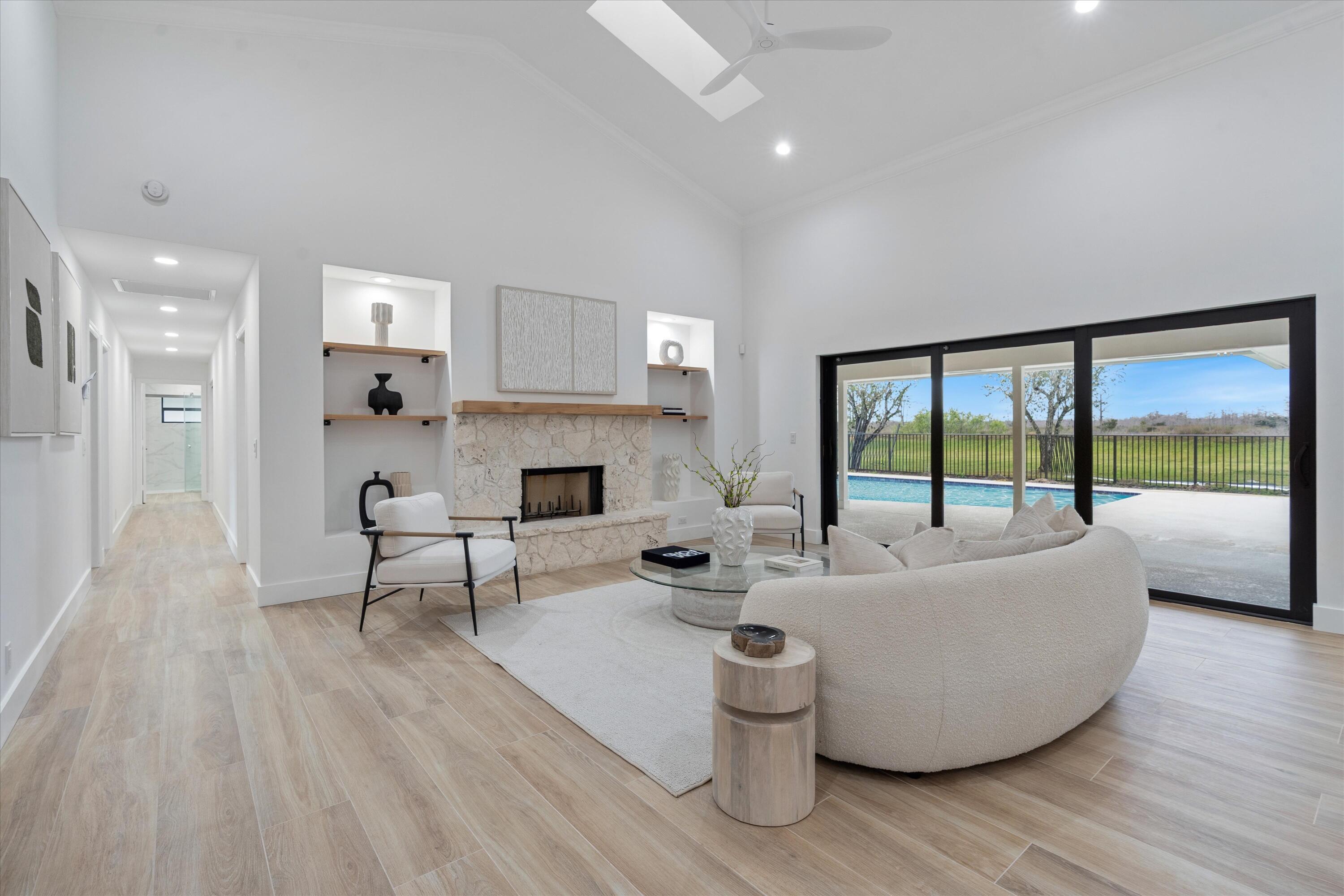 24 Dunbar Road Palm Beach Gardens, FL 33418 - Photo 5 of 93 a living room with furniture and a fireplace