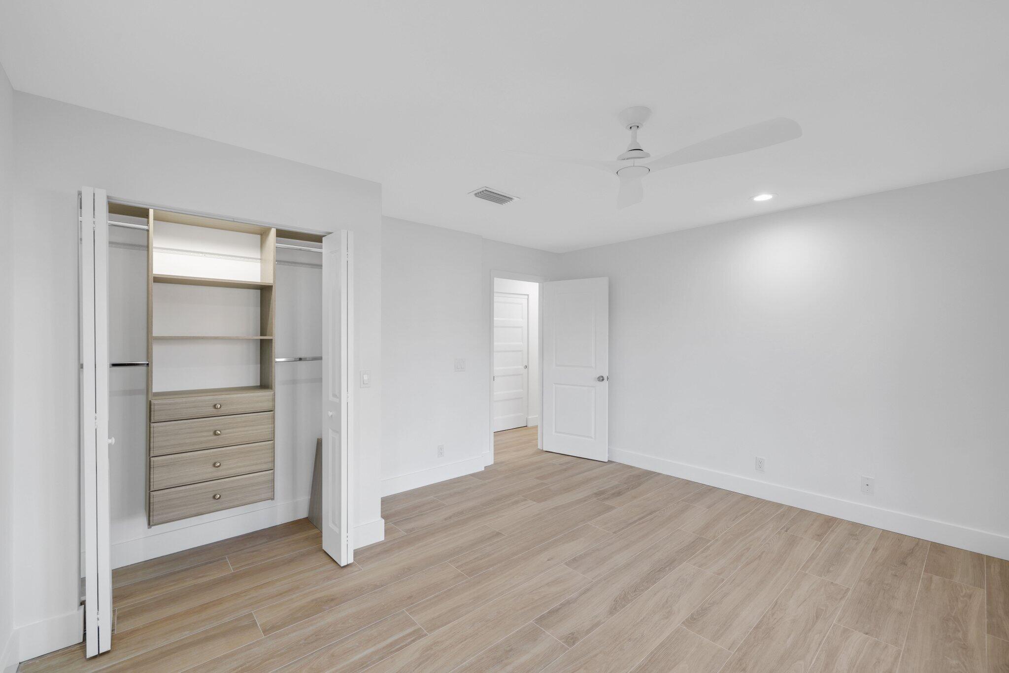 24 Dunbar Road Palm Beach Gardens, FL 33418 - Photo 54 of 93 a view of walk in closet with empty racks