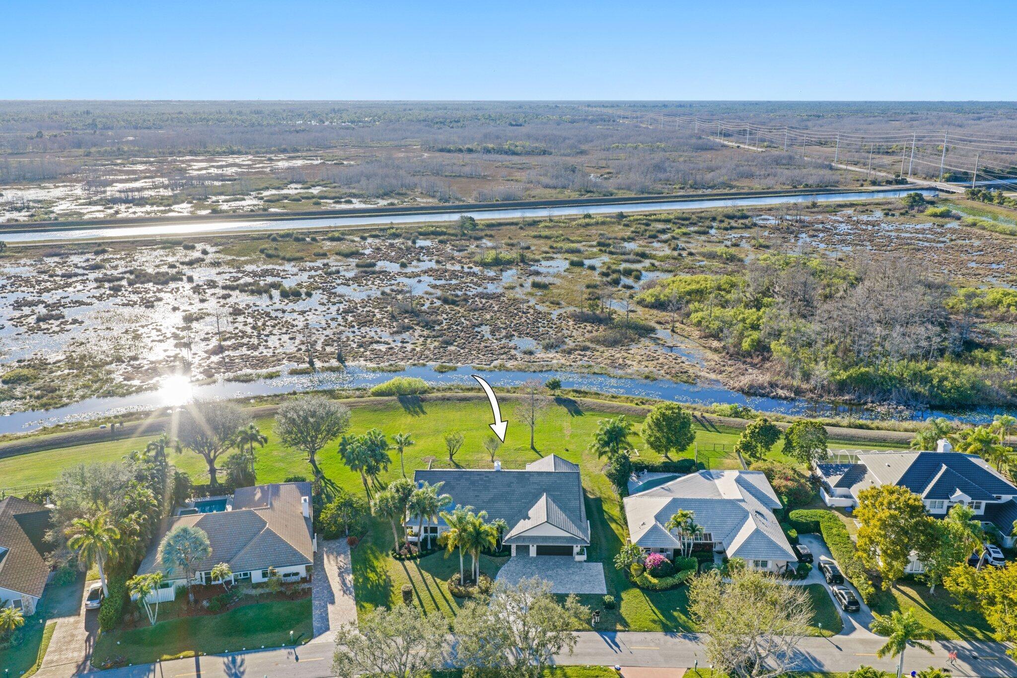 24 Dunbar Road Palm Beach Gardens, FL 33418 - Photo 85 of 93 an aerial view of a swimming pool and lake view