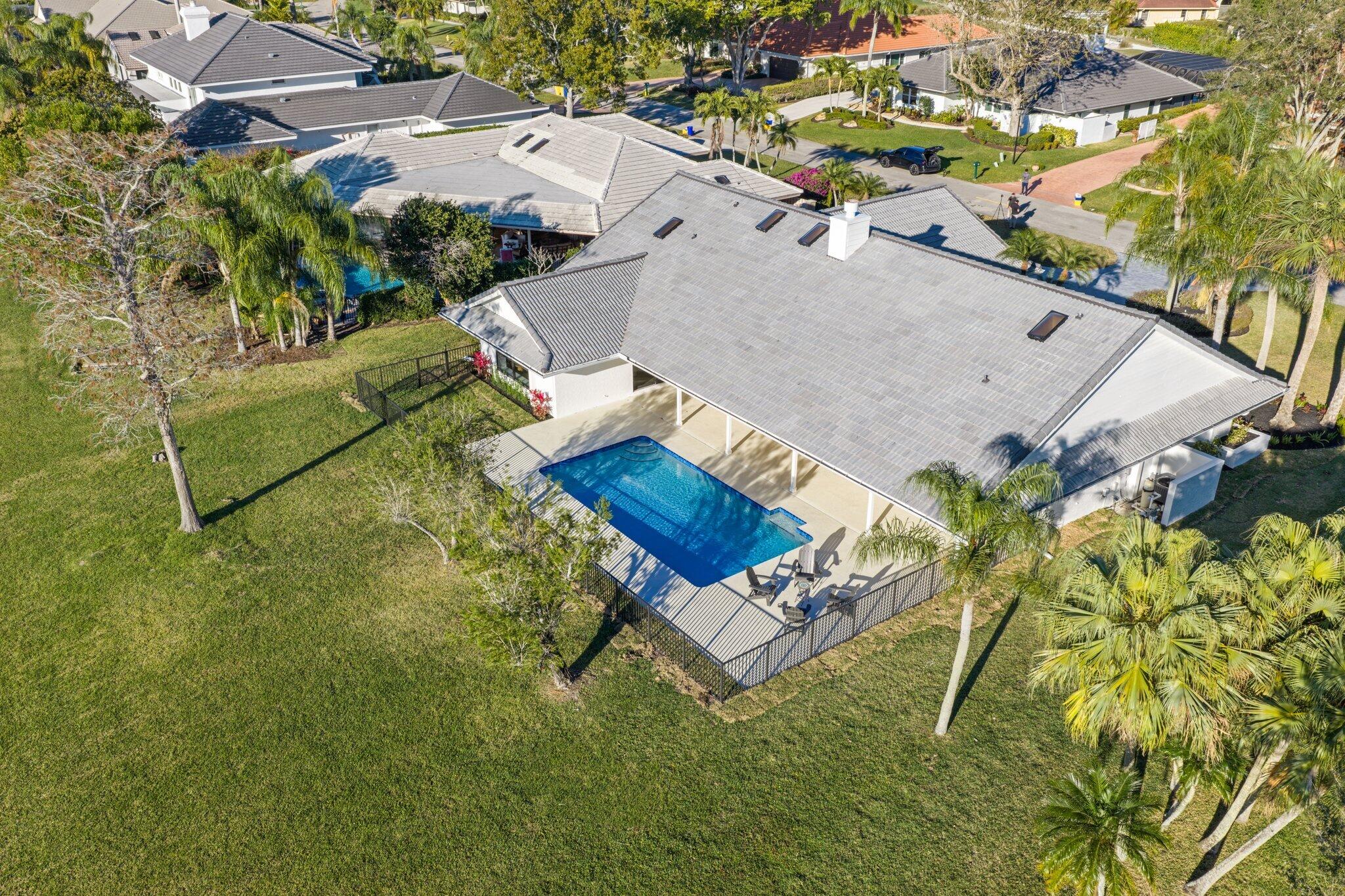 24 Dunbar Road Palm Beach Gardens, FL 33418 - Photo 89 of 93 an aerial view of a house with a garden and swimming pool