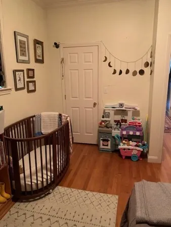 a bedroom with furniture and a wooden floor