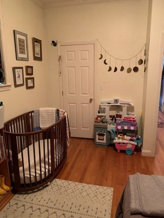 328 Sumner Street, Unit 2 Boston, MA 02128 - Photo 11 of 15 a bedroom with furniture and a wooden floor