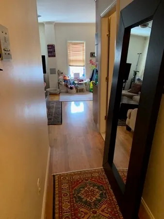 a view of hallway with furniture and a window