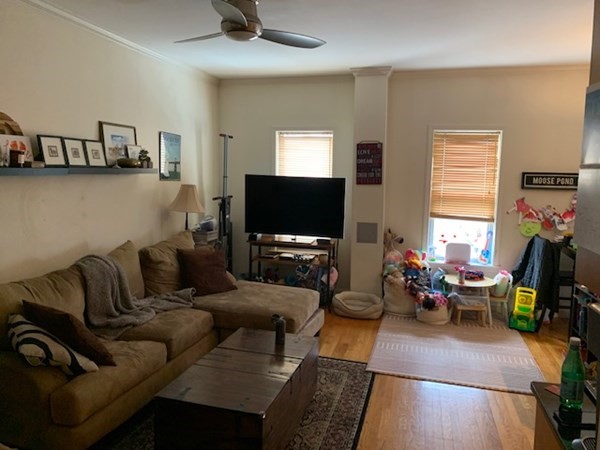 328 Sumner Street, Unit 2 Boston, MA 02128 - Photo 4 of 15 a living room with furniture and a flat screen tv